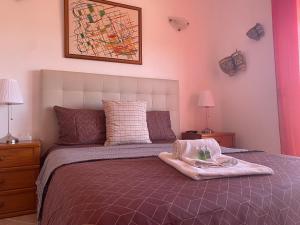 a bedroom with a bed with a blanket and two lamps at Lagos Marina Guest House in Lagos