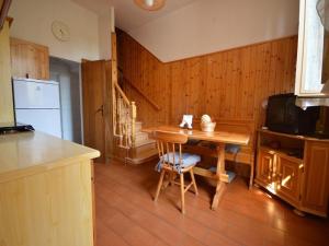 a kitchen with a wooden table and a small table with chairs at Piana, Bologna by Short Holidays in Bologna