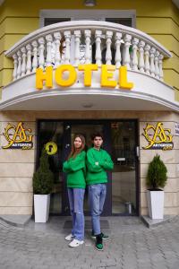 a man and a woman standing in front of a hotel at Art Green Boutique Hotel in Varna City