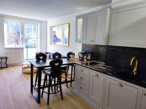 a kitchen with a table and some chairs and a counter at Bad Gastein Historic Center in Bad Gastein