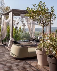 a patio with a bed and a gazebo at Villa Alma Vista in Dobrovo