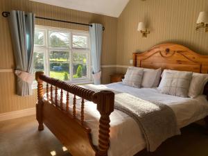 a bedroom with a bed and a large window at The Egerton Arms Astbury in Congleton