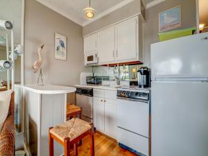 uma cozinha com armários brancos e um frigorífico branco em Seaside Villa 332, 1 Bedroom, Pool, Oceanside, 3rd Floor, Wi-Fi, Sleeps 4 em Hilton Head Island