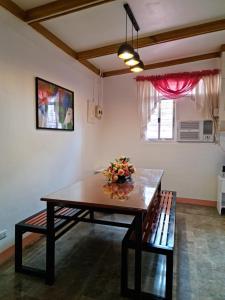 a dining room with a table and a bench at 150 Lucap Road in Alaminos