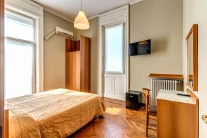 1 dormitorio con 1 cama y escritorio en una habitación en Hotel Apollo en Milán