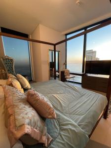 Krevet ili kreveti u jedinici u okviru objekta LHG ADDRESS BEACHFRONT +21 fotografija