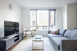 a living room with a couch and a tv at SoMa 2BR Gym Roofdeck nr Muni Whole Foods SFO-296 in San Francisco