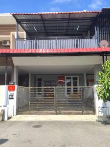 a building with a gate and stairs in front of it at cs homestay in Kuantan