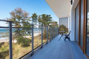 a balcony with a view of the beach at VacationClub - Let’s Sea Baltic Park C83 in Gąski