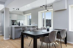 a kitchen and dining room with a black table and chairs at Strandresidenzen Binz-Prora Strandresidenzen Binz-Prora V5 1 in Binz