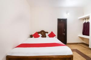 a bedroom with a large bed with red pillows at OYO Flagship 64921 Purple Villa in Bhubaneshwar