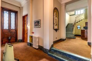 a hallway with stairs and a door and a stair case at Hotel Apollo in Milan