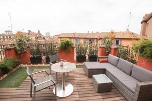 a patio with a couch and a table and chairs at Otivm Hotel in Rome