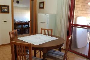 a table and chairs in a kitchen with a refrigerator at appartamento a 700 mt. dal mare. in Terracina