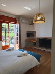 a bedroom with a large bed with towels on it at Casa Teranga in Furore