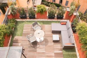 an aerial view of a patio with chairs and an umbrella at Otivm Hotel in Rome