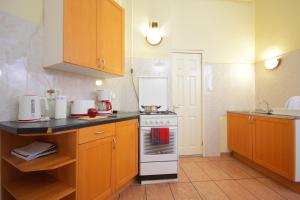 a small kitchen with a stove and a sink at Blue Rose Apartment in Budapest