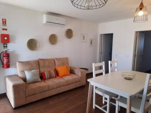 a living room with a couch and a table at Sado House 3 in Comporta