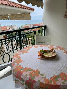 a table with a bowl of food on a balcony at Nea Skioni apartment in Nea Skioni