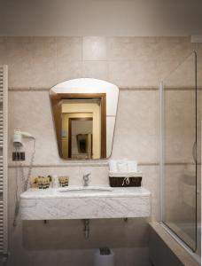 a bathroom with a sink and a mirror at Hotel Riviera in Desenzano del Garda