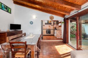 a kitchen and living room with a table and a television at Suite Harmony in Loiri