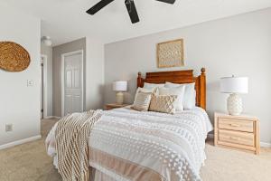 a bedroom with a large bed with a wooden headboard at Sun of a Beach in Manteo