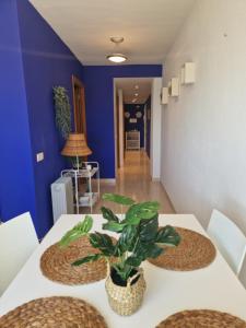 a dining room with a white table with a plant on it at Vistas Mágicas Mar Mediterraneo in Oropesa del Mar