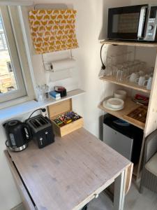 a table in a tiny kitchen with a microwave at Amsterdam Boat Studio in Amsterdam