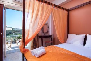 a bedroom with a bed and a window with a view at Elena Studios and apartments in Nea Iraklia