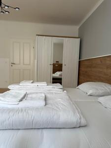 a bedroom with two beds with white sheets at Lion`s Rooms n Apartments in Vienna