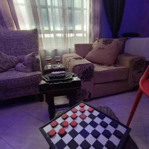 a living room with a checkerboard chessboard on a table at Kentania Hotel & Spa, Nakuru - Kenya in Nakuru