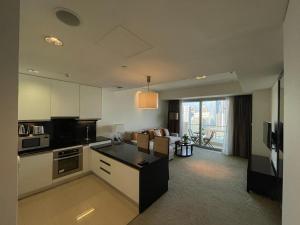 a large kitchen and living room with a couch at The Address Dubai Marina in Dubai