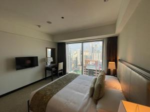 a hotel room with a bed and a large window at The Address Dubai Marina in Dubai