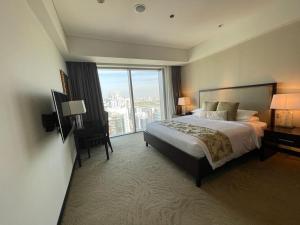a hotel room with a bed and a large window at The Address Dubai Marina in Dubai