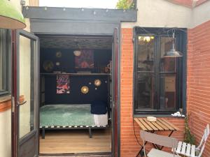 a small room with a bed in a doorway at Casa Rural Alfoz, -Tiny house- con patio privado y barbacoa in Velliza
