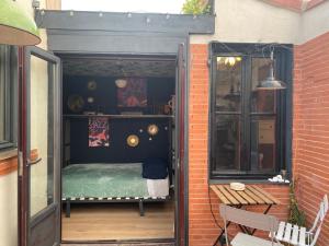 a small room with a bed in a doorway at Casa Rural Alfoz, -Tiny house- con patio privado, barbacoa, wifi, netflix, Aire acondicionado in Velliza