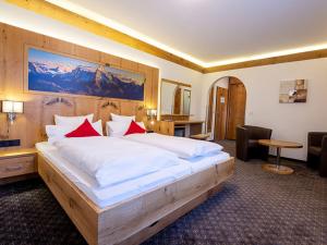 Ein Bett oder Betten in einem Zimmer der Unterkunft Alpenhotel Denninglehen