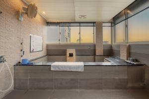 a bathroom with a counter with a sink in it at 沐-湯宿溫泉行旅 in Jiaoxi