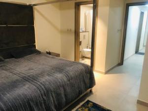 a bedroom with a large bed and a bathroom at Brown Stone Holiday Homes MH in Dubai
