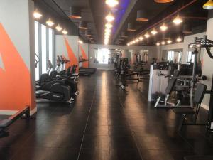 a gym with lots of treadmills and machines at Brown Stone Holiday Homes MH in Dubai