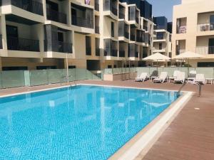 a large swimming pool in front of a building at Brown Stone Holiday Homes MH in Dubai
