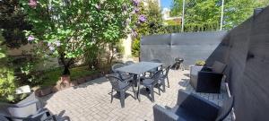 a patio with a table and chairs in a backyard at Spacious House in Düsseldorf