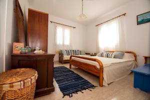 a bedroom with a bed and a table and a couch at Maria Nik Psaras House in Kalymnos