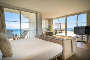 a living room with a bed and a large window at INNSiDE by Meliá Calviá Beach in Magaluf