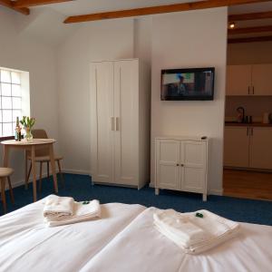 a bedroom with a bed with two towels on it at Apartamenty Na Fali in Jastarnia +81 photos