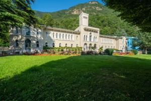 a large building with a large lawn in front of it at Hotel & Spa Radiana in La Léchère