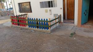 a wooden picket fence in front of a house at Appartement / Logement Imsouane. in Imsouane +2 photos
