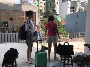 a group of people standing around with luggage at Homestay giường tầng view thoáng tại Bãi Cháy Hạ Long in Ha Long