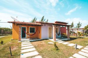 a small house with a pathway leading up to it at Vila Capininga Ecopousada in Santo Amaro