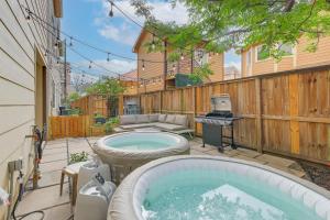 a backyard with a hot tub and a grill at Houston Vacation Rental about 1 Mi to Downtown! in Houston